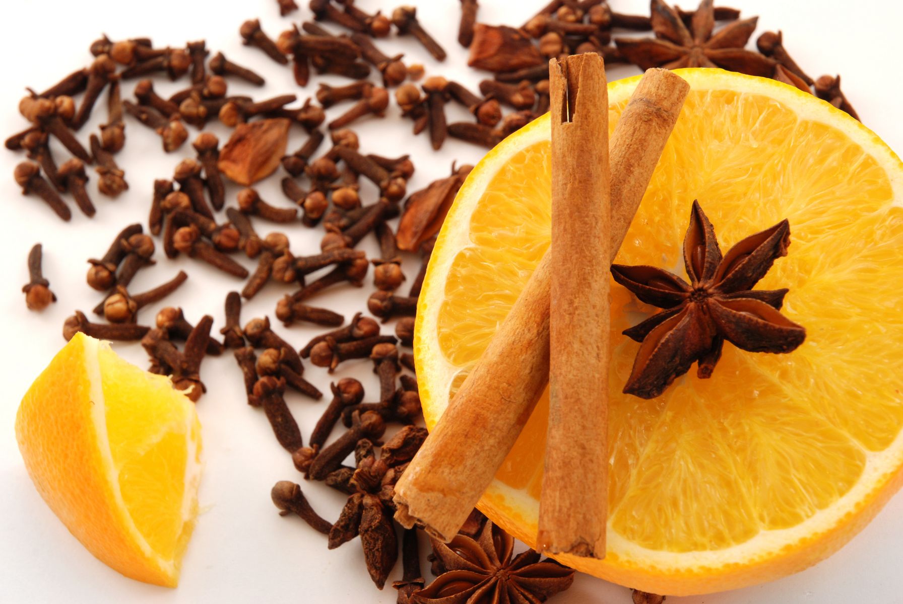 Clove, cinnamon sticks, star anise  and a sliced open orange | photo: © Skoric | Dreamstime.com 